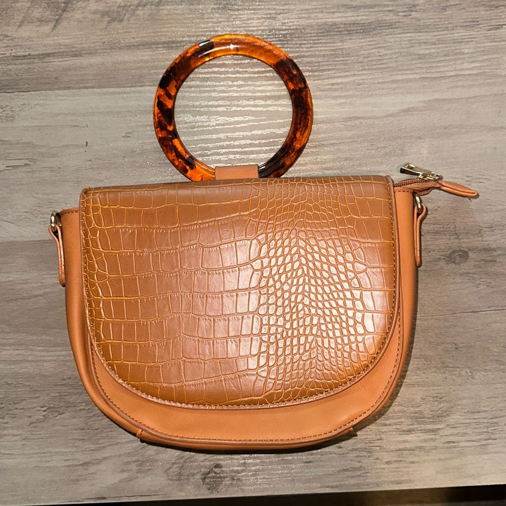 Brand new never used stylish clutch. Includes crossbody strap.